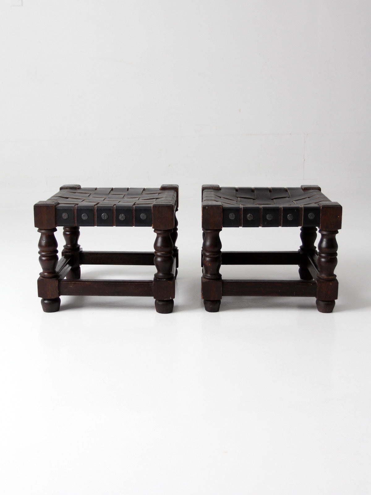 mid-century Spanish Revival leather strap stools pair