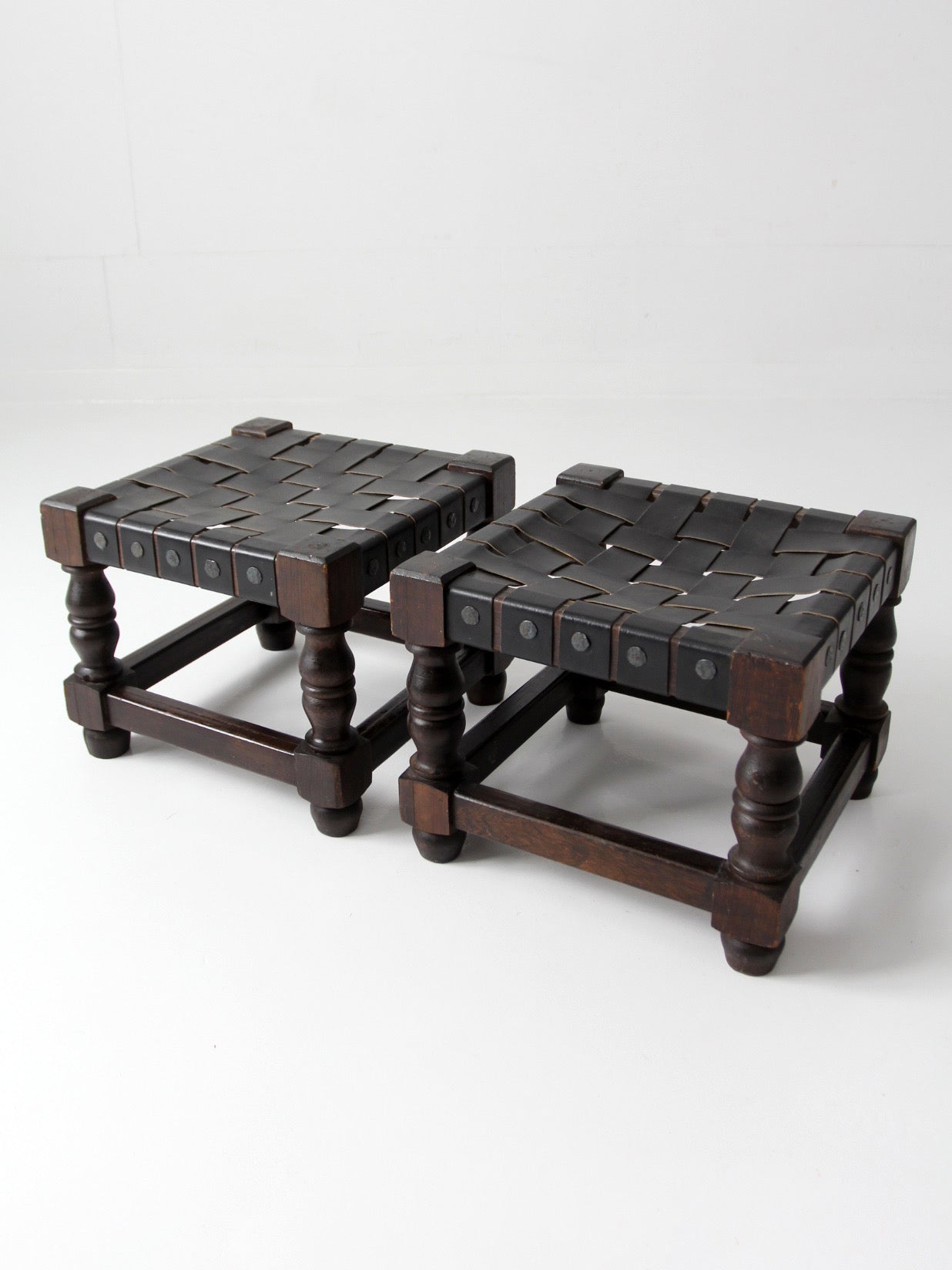 mid-century Spanish Revival leather strap stools pair