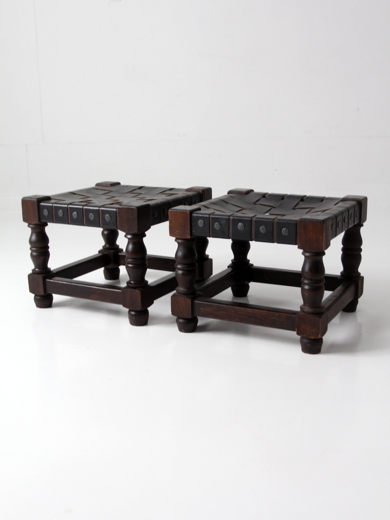 mid-century Spanish Revival leather strap stools pair