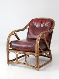 antique rattan lounge chair with oxblood cushions