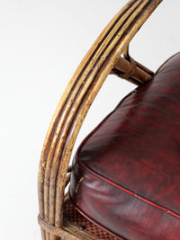 antique rattan lounge chair with oxblood cushions