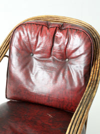 antique rattan lounge chair with oxblood cushions