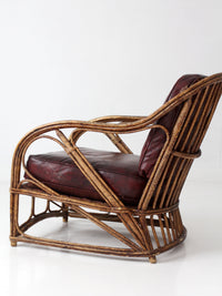 antique rattan lounge chair with oxblood cushions