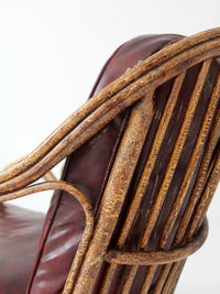 antique rattan lounge chair with oxblood cushions