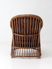 antique rattan lounge chair with oxblood cushions