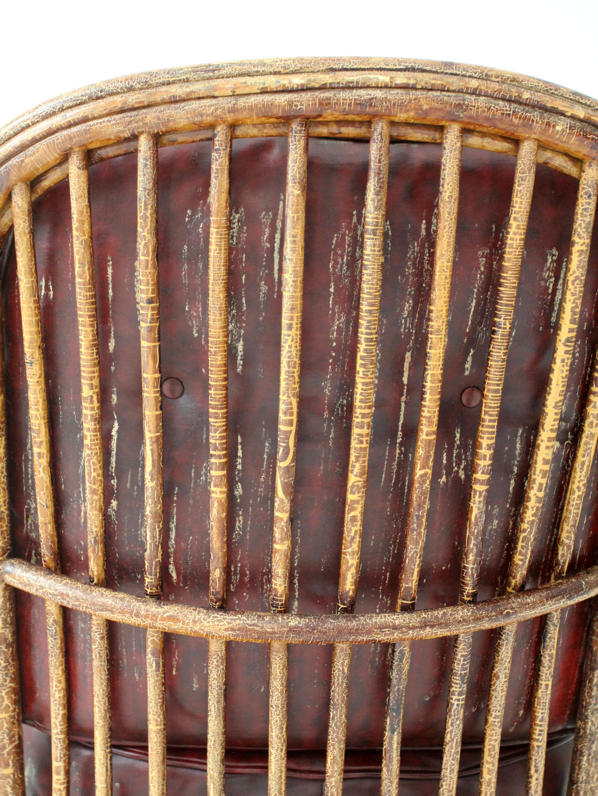 antique rattan lounge chair with oxblood cushions
