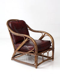 antique rattan lounge chair with oxblood cushions