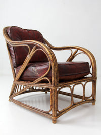 antique rattan lounge chair with oxblood cushions