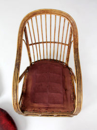 antique rattan lounge chair with oxblood cushions