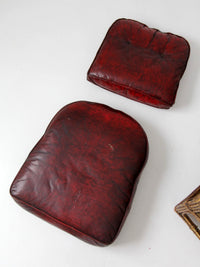 antique rattan lounge chair with oxblood cushions