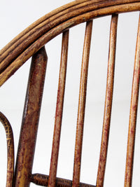 antique rattan lounge chair with oxblood cushions