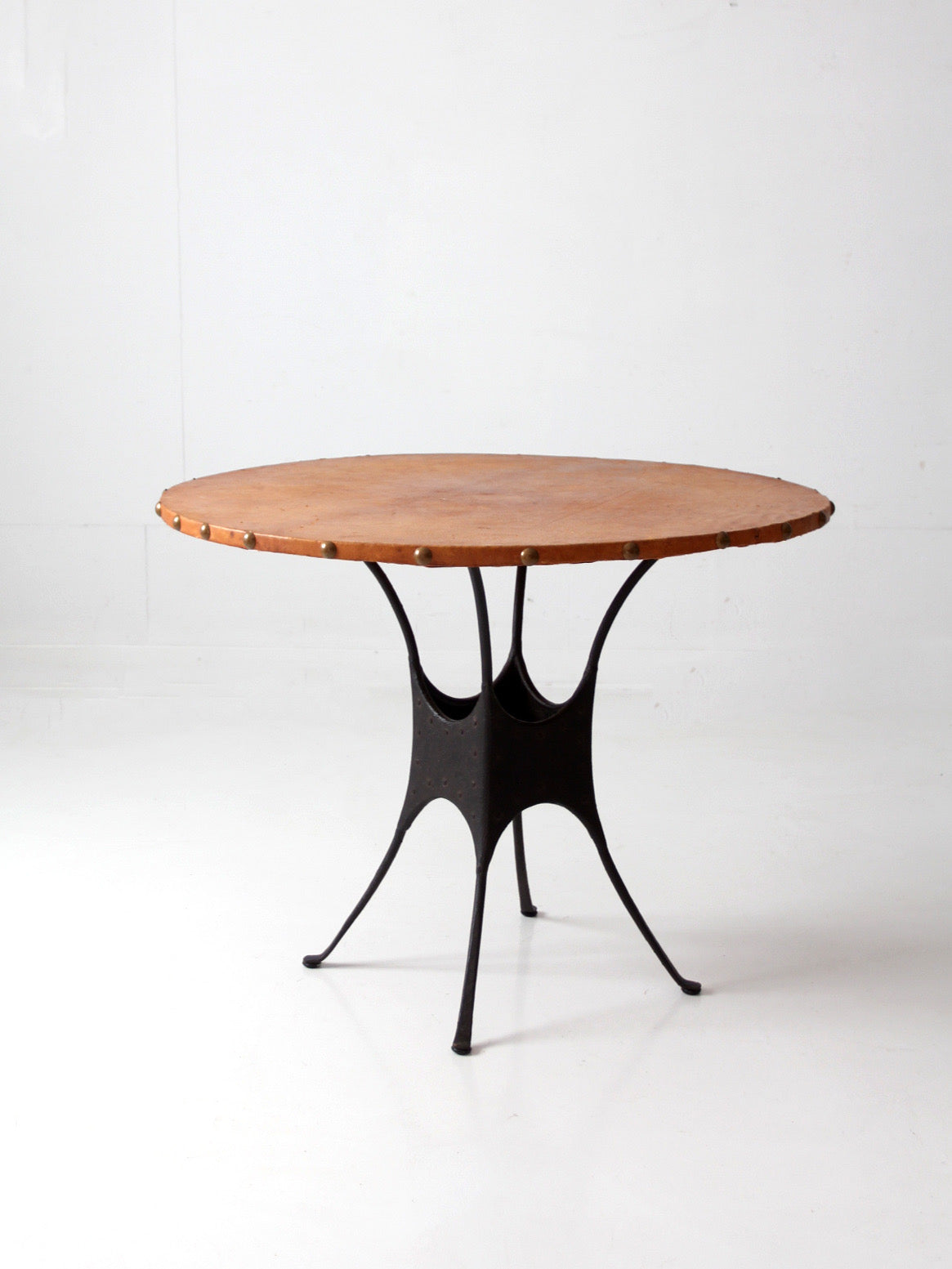 mid-century leather and iron round dining table