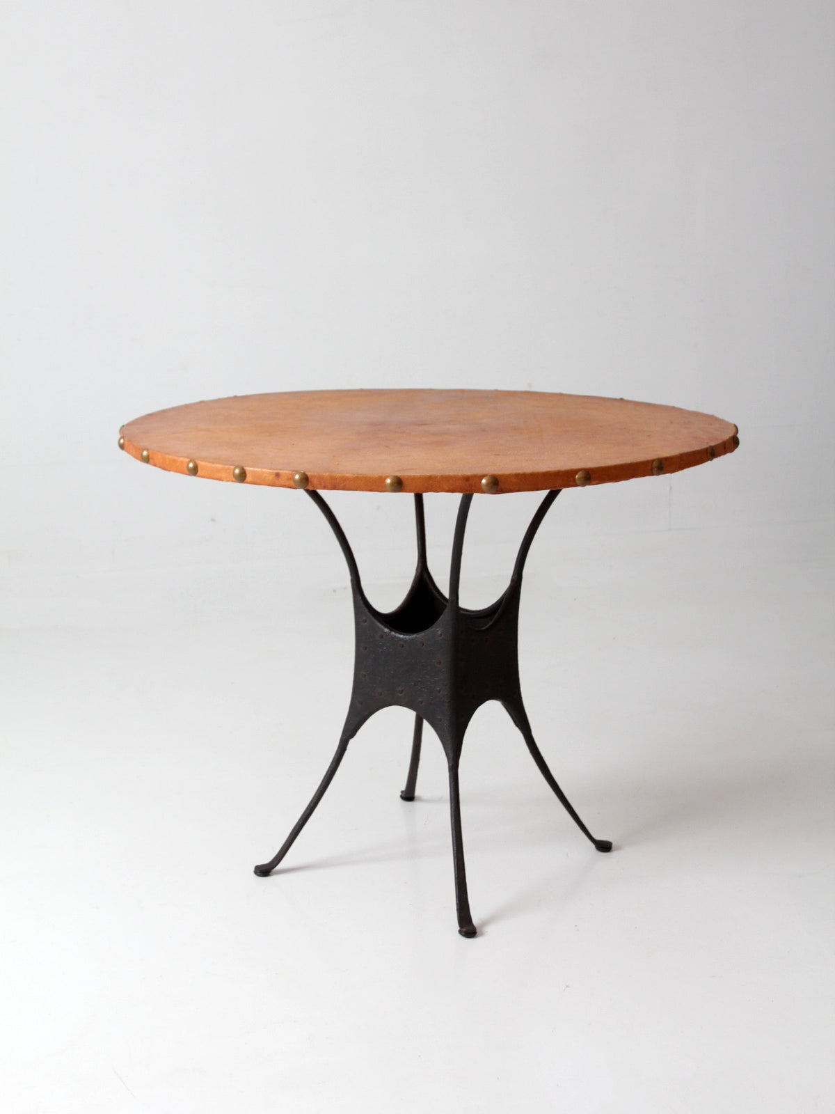 mid-century leather and iron round dining table
