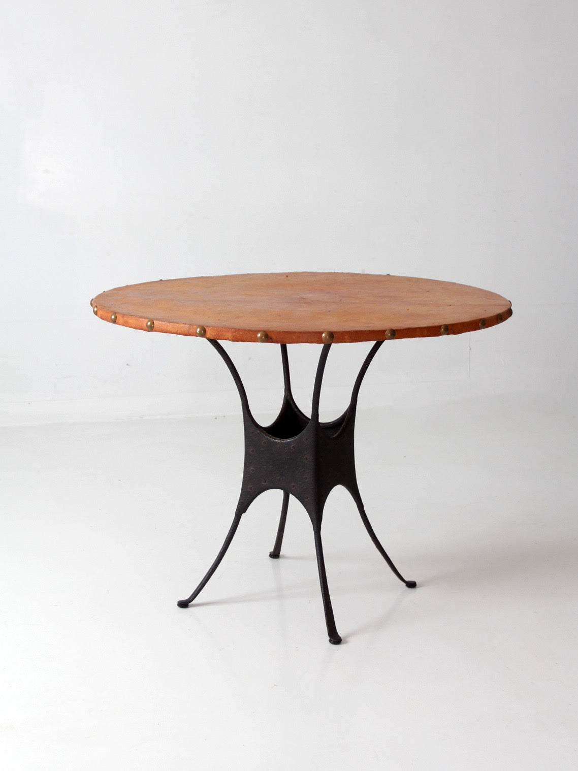 mid-century leather and iron round dining table