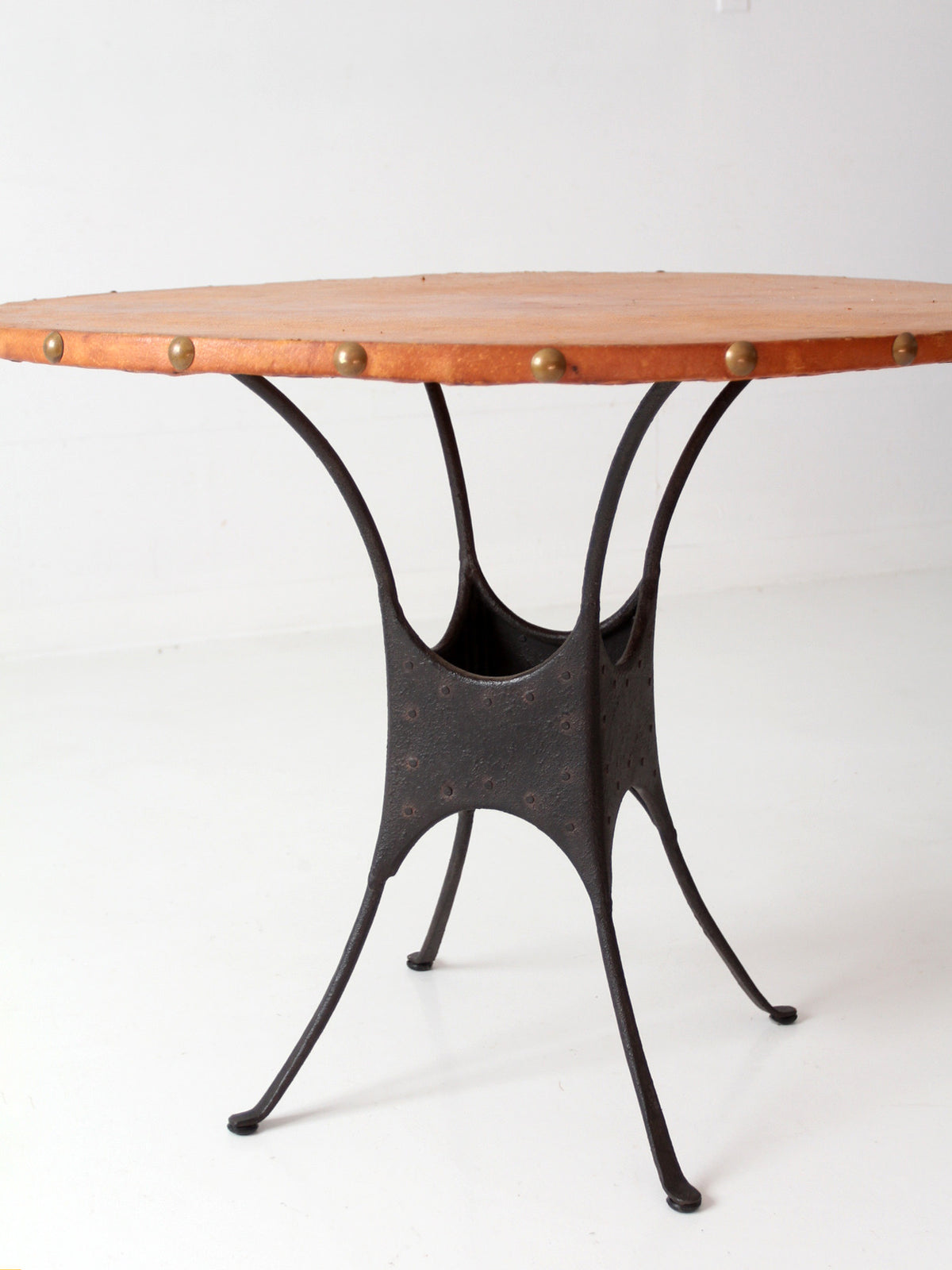 mid-century leather and iron round dining table