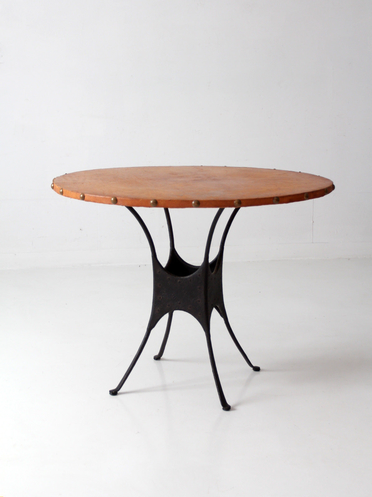 mid-century leather and iron round dining table