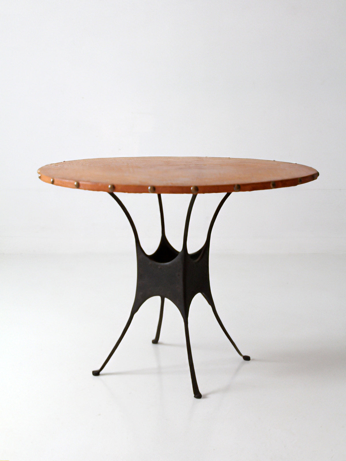 mid-century leather and iron round dining table