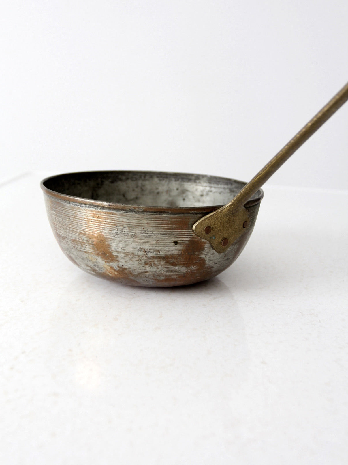 antique copper saucepan with brass handle