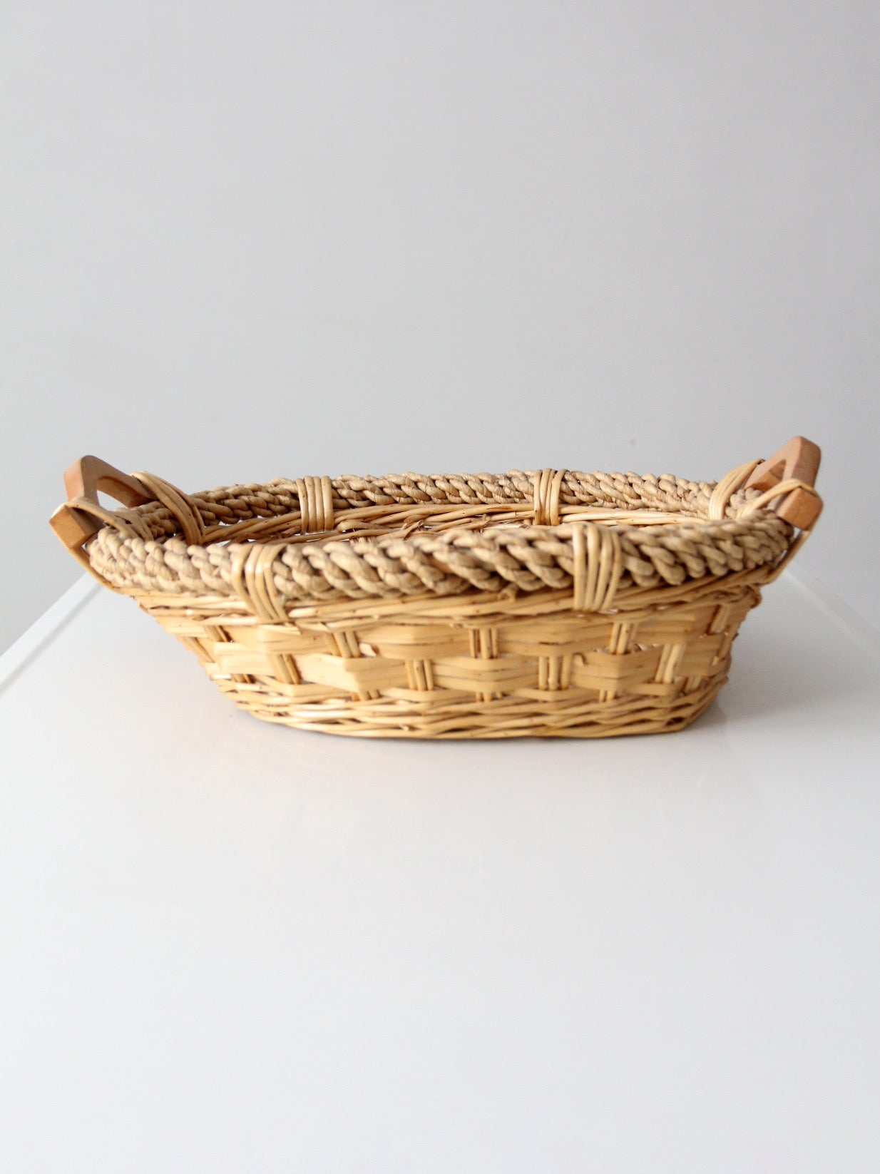 vintage wicker catchall basket with wooden handles