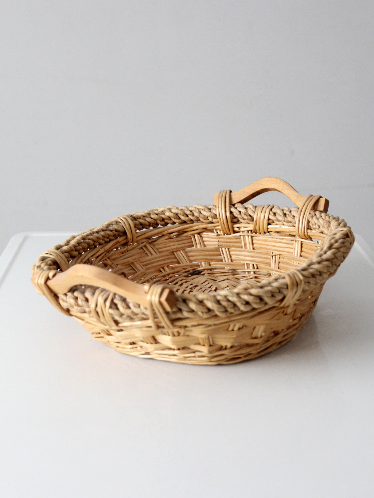 vintage wicker catchall basket with wooden handles
