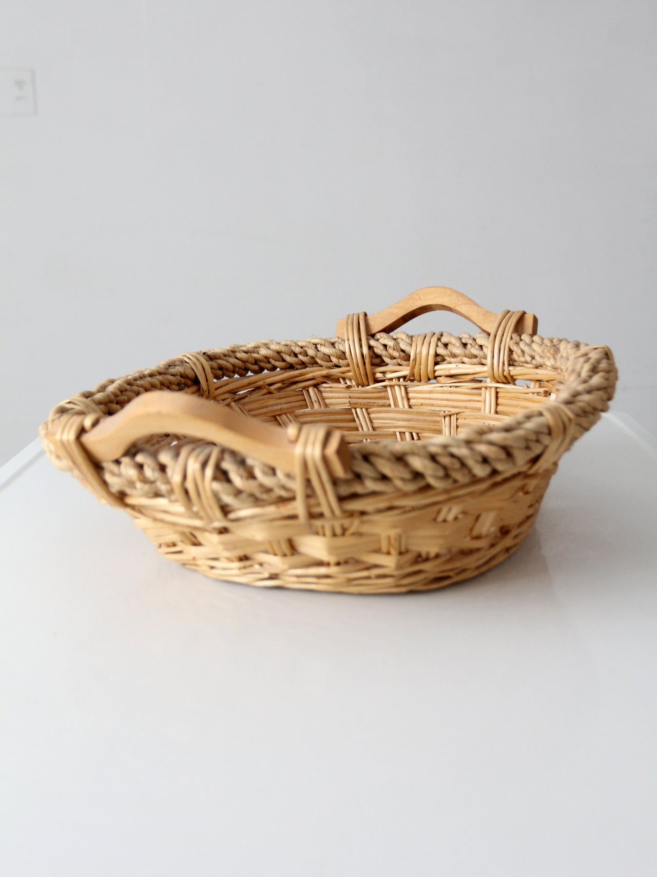 vintage wicker catchall basket with wooden handles