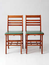 pair of 1950s wooden folding chairs with green seats