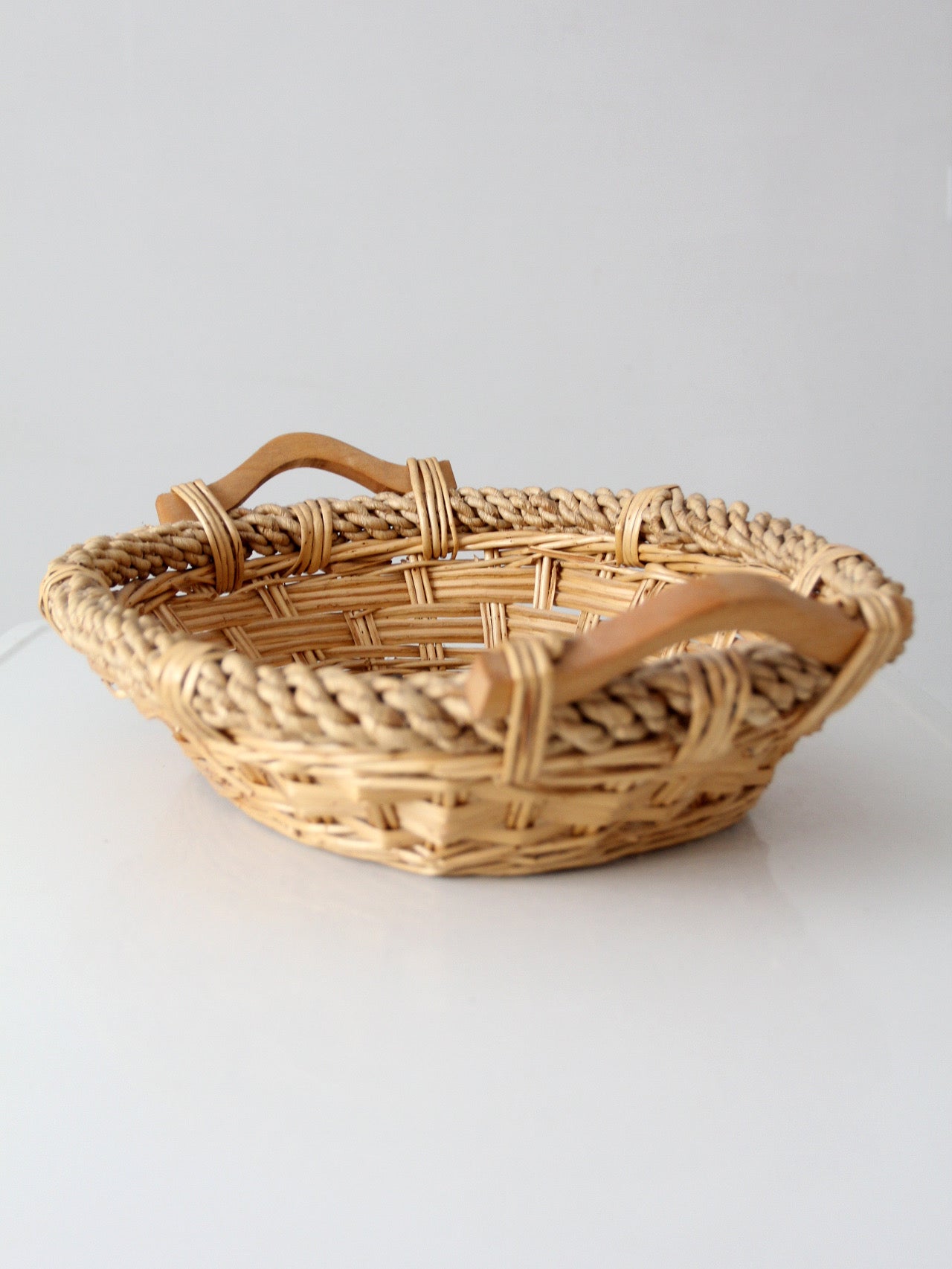 vintage wicker catchall basket with wooden handles