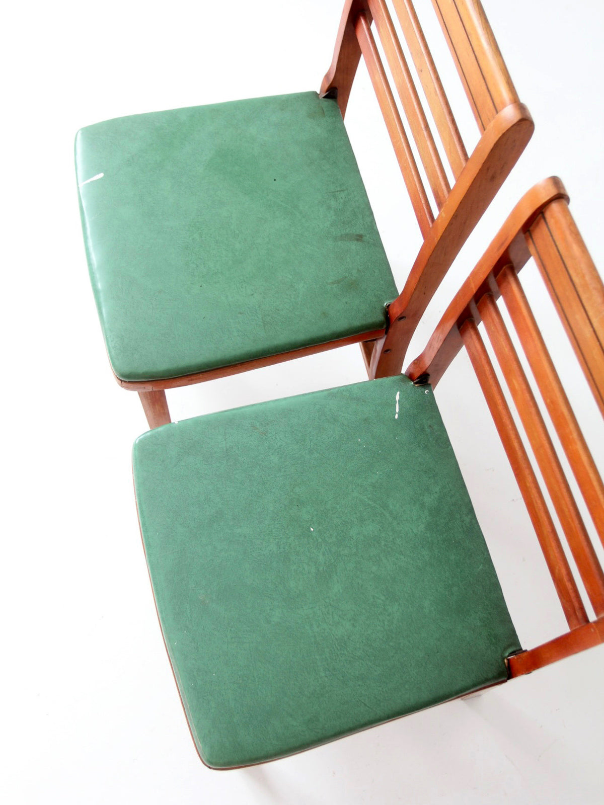 pair of 1950s wooden folding chairs with green seats