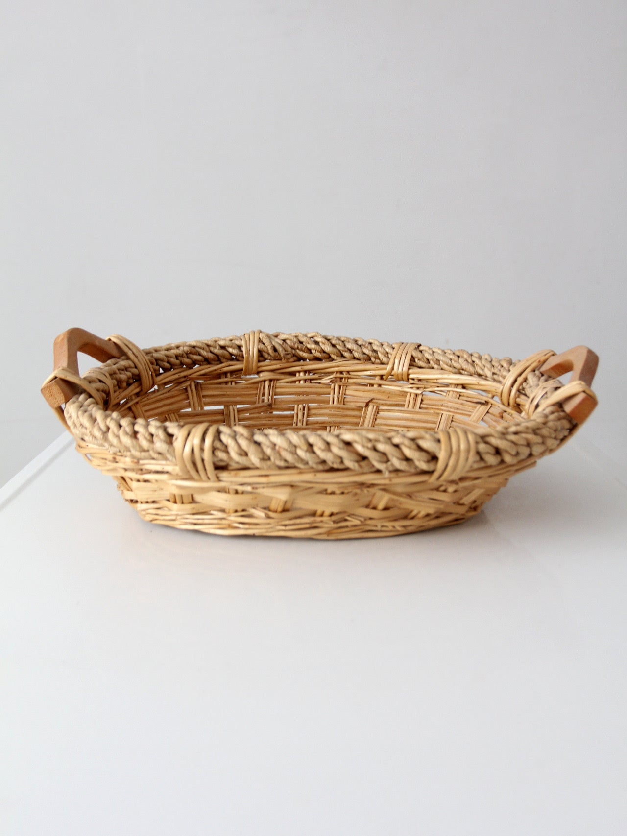 vintage wicker catchall basket with wooden handles