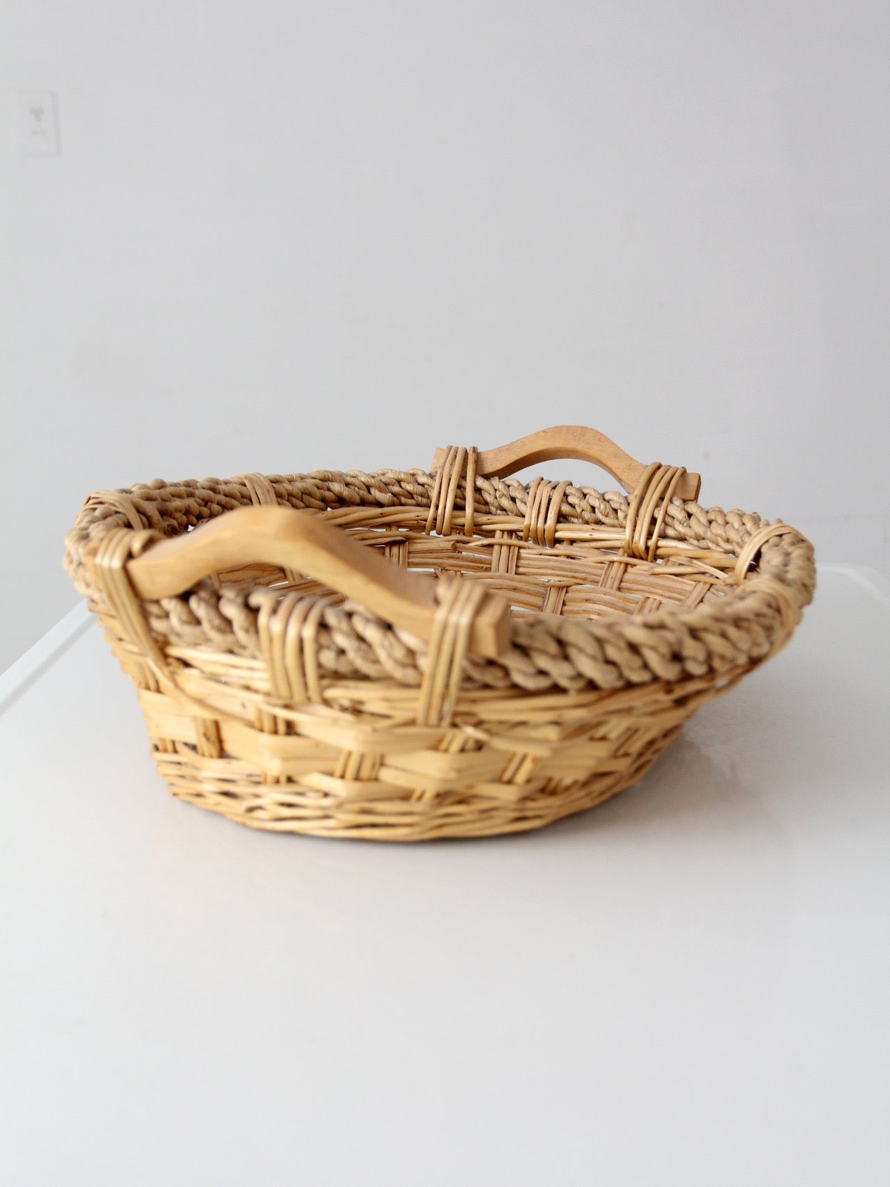 vintage wicker catchall basket with wooden handles
