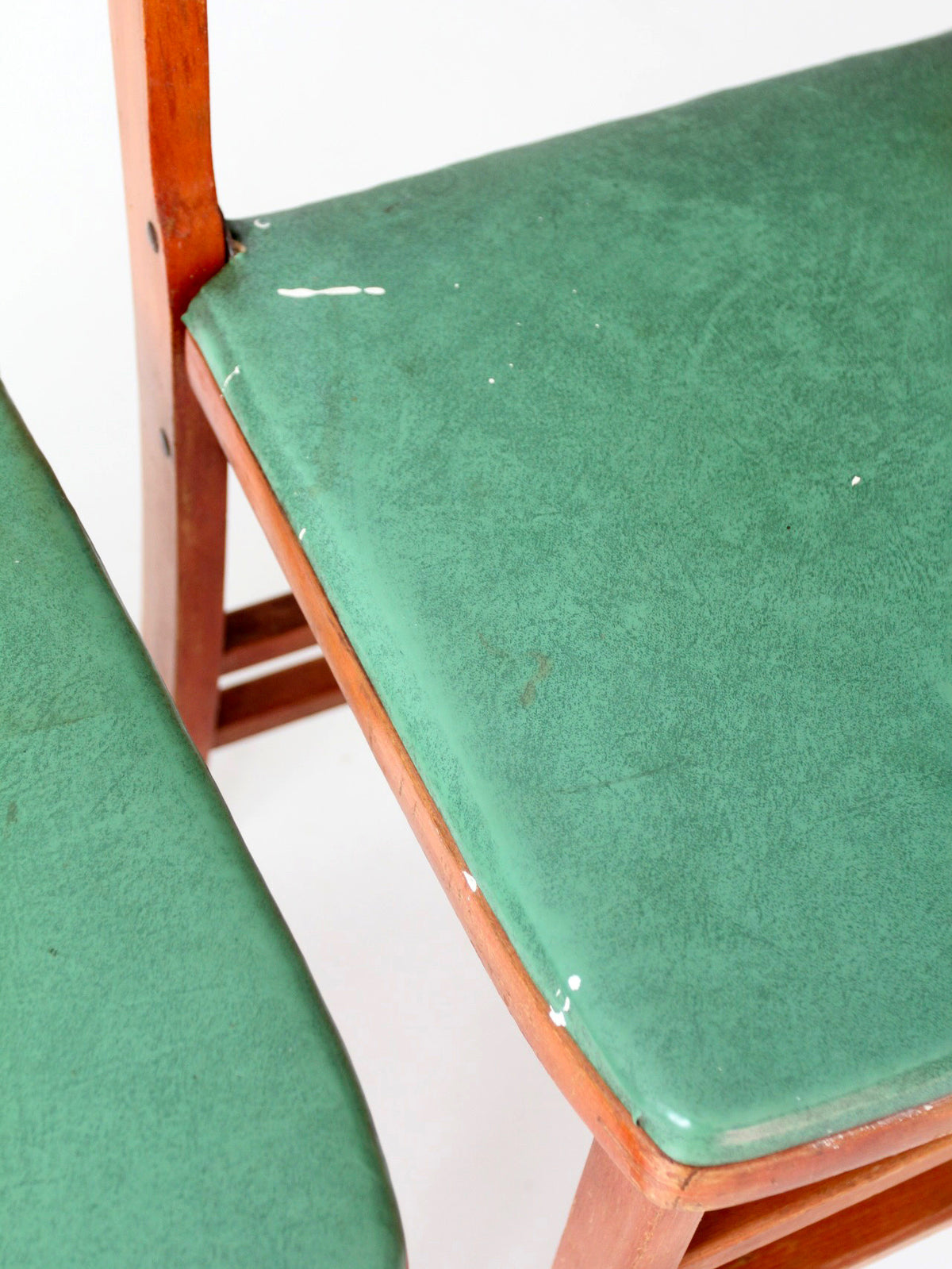 pair of 1950s wooden folding chairs with green seats