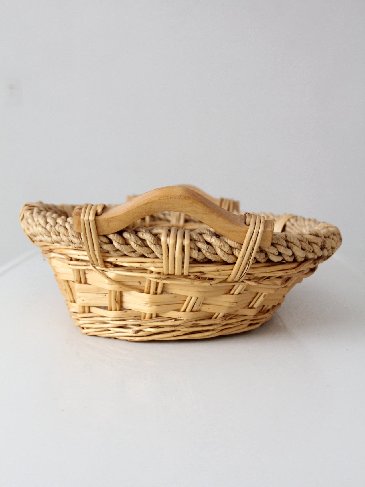 vintage wicker catchall basket with wooden handles