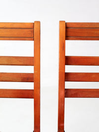 pair of 1950s wooden folding chairs with green seats