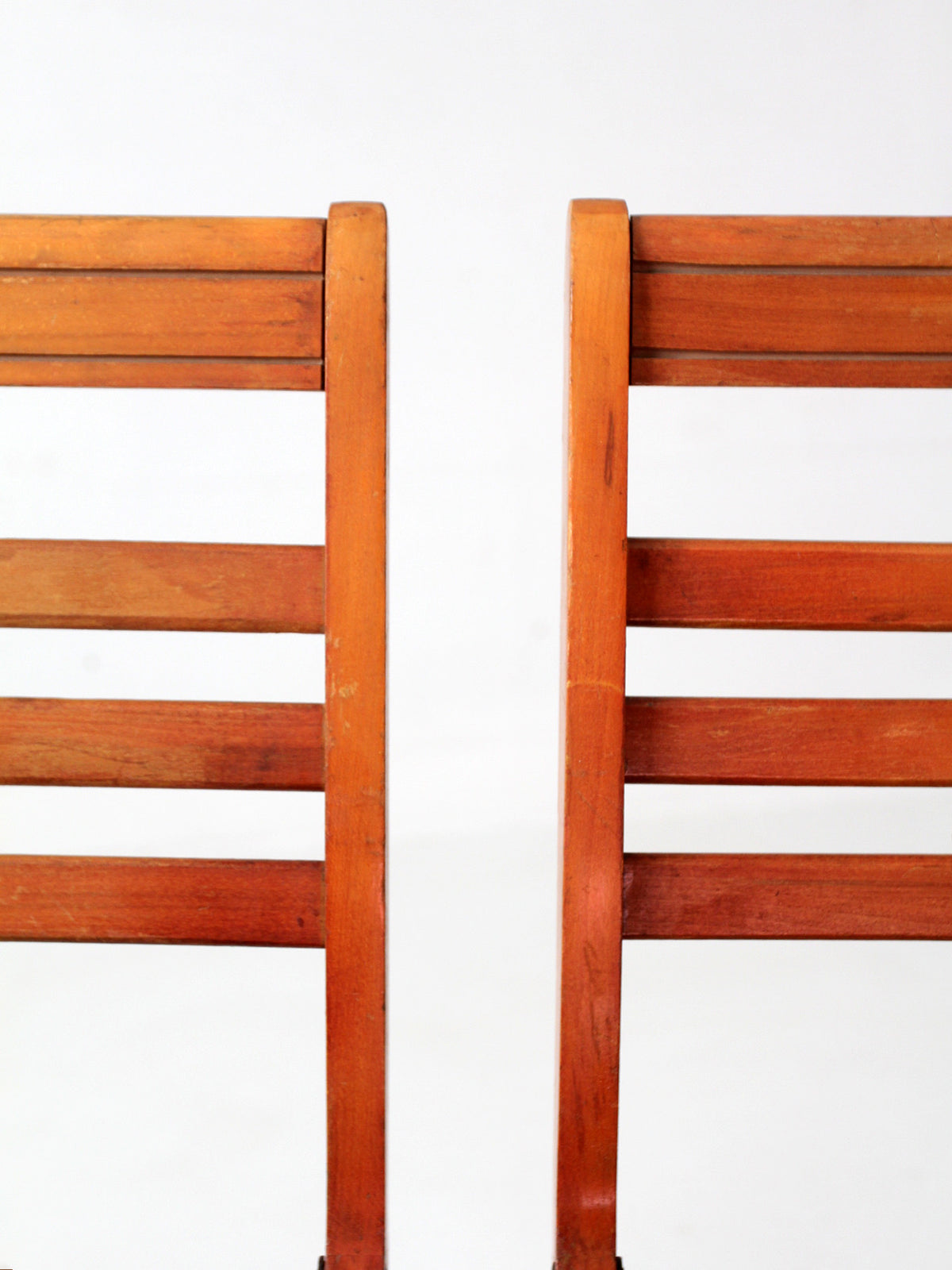 pair of 1950s wooden folding chairs with green seats