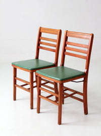 pair of 1950s wooden folding chairs with green seats
