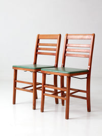 pair of 1950s wooden folding chairs with green seats