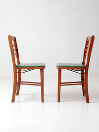 pair of 1950s wooden folding chairs with green seats