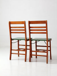 pair of 1950s wooden folding chairs with green seats