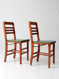 pair of 1950s wooden folding chairs with green seats