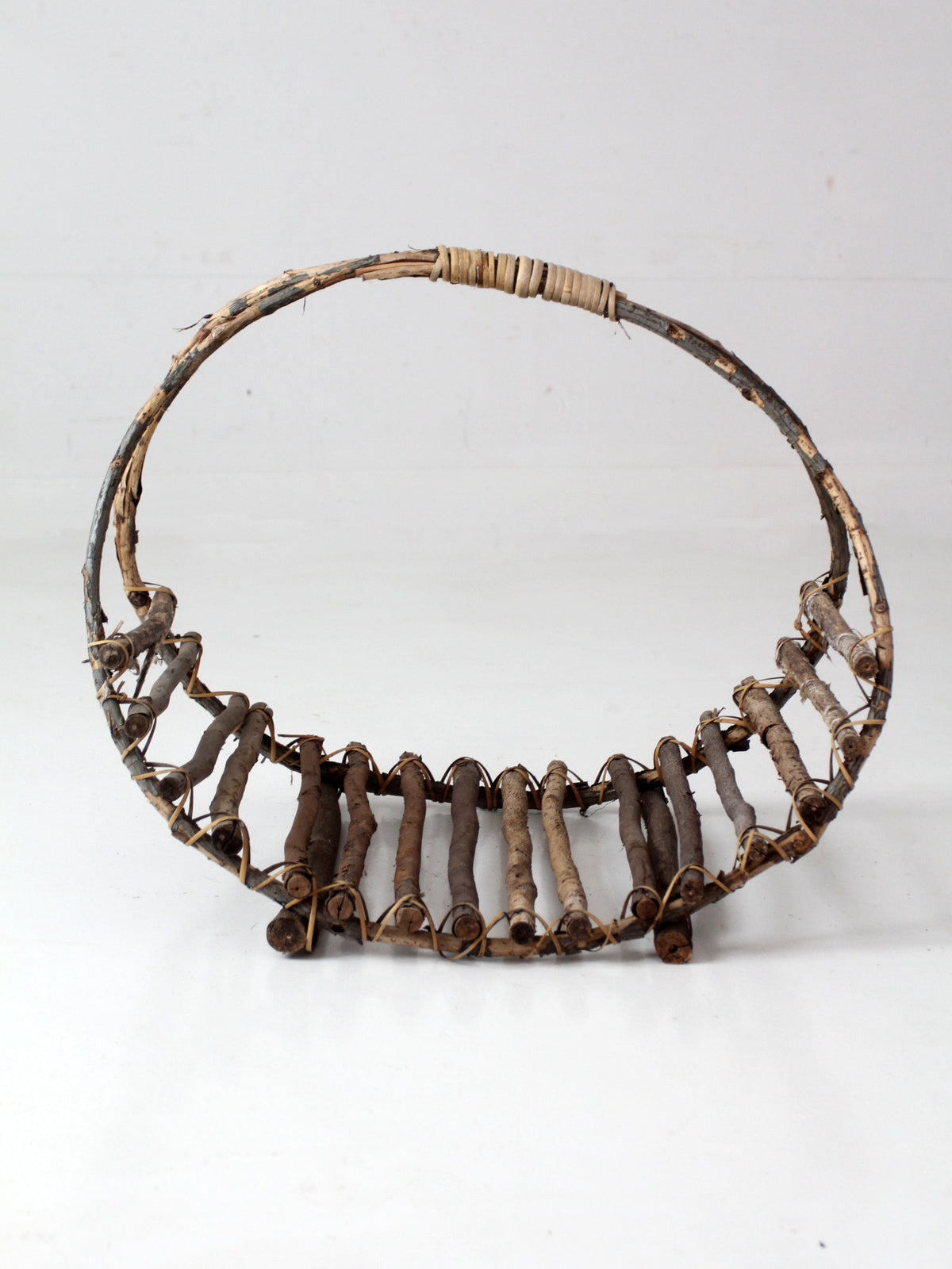 vintage rustic twig basket with arched handle