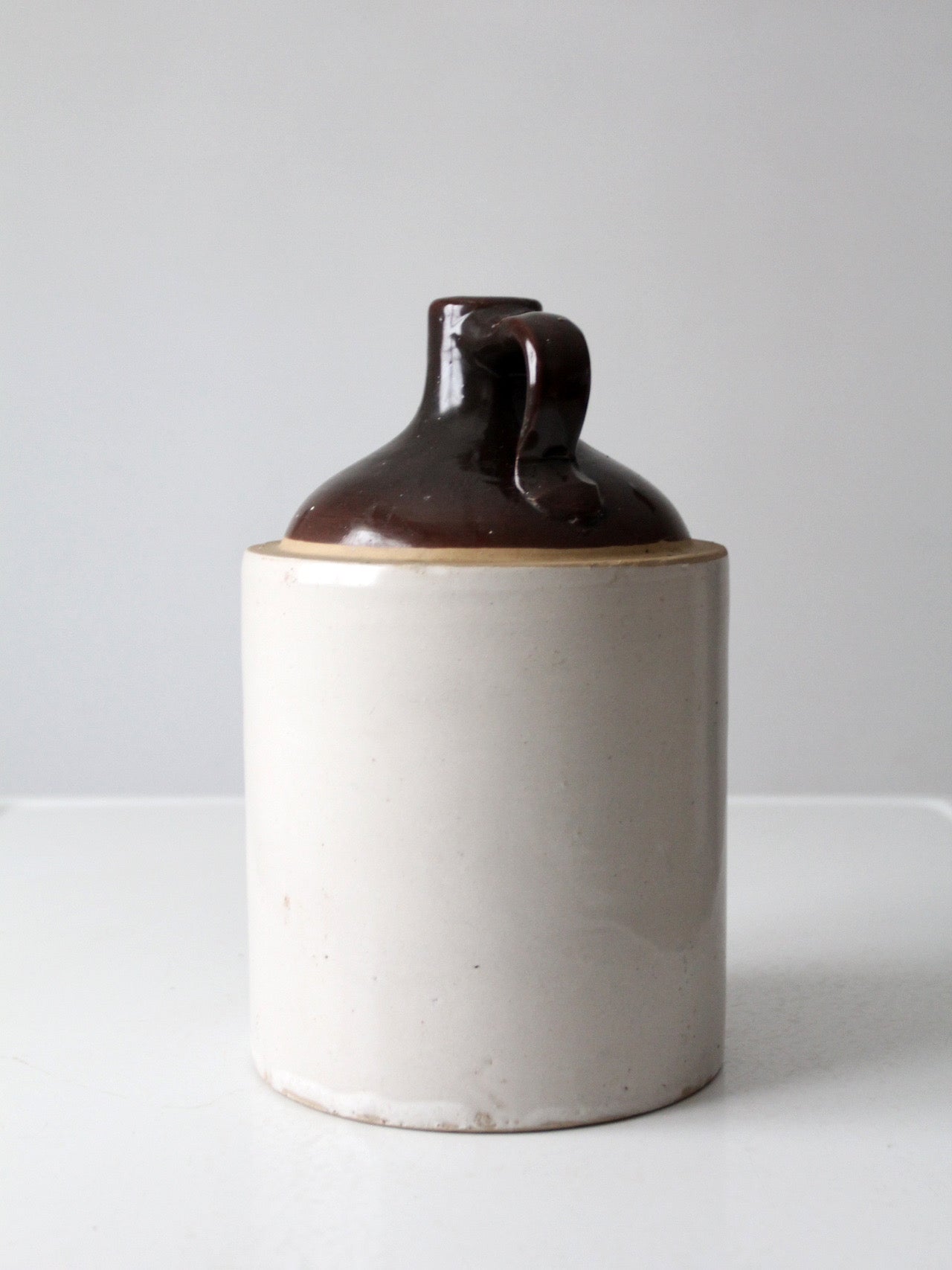 antique stoneware jug with brown glaze