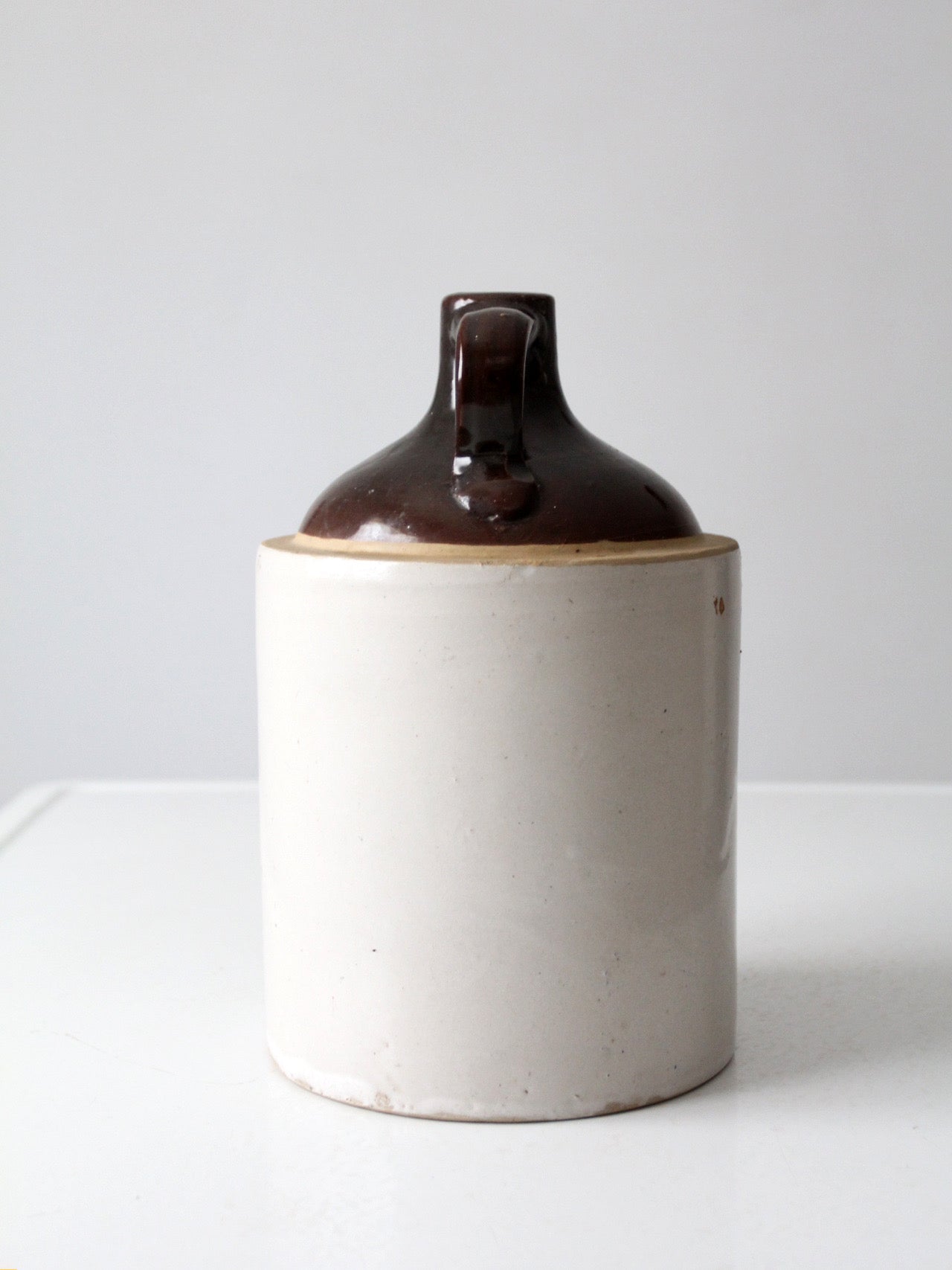 antique stoneware jug with brown glaze