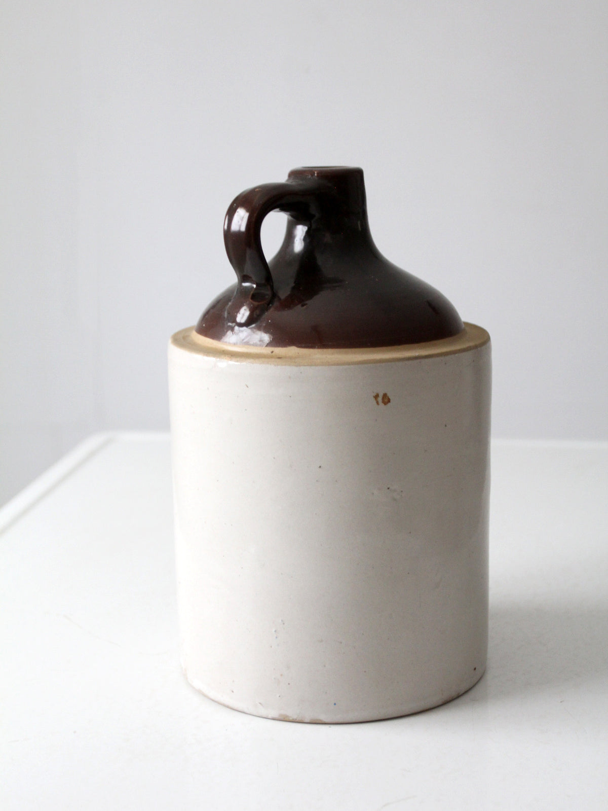 antique stoneware jug with brown glaze