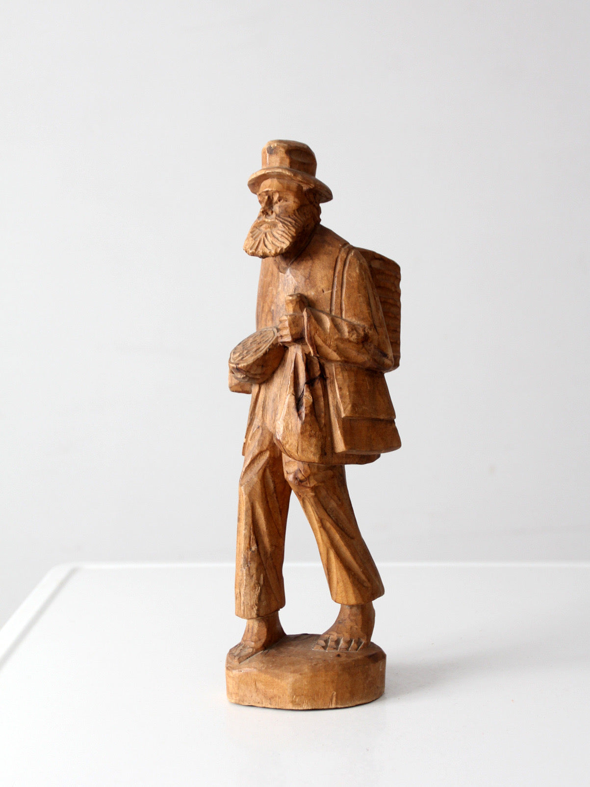 mid-century folk art carved wood peddler figure