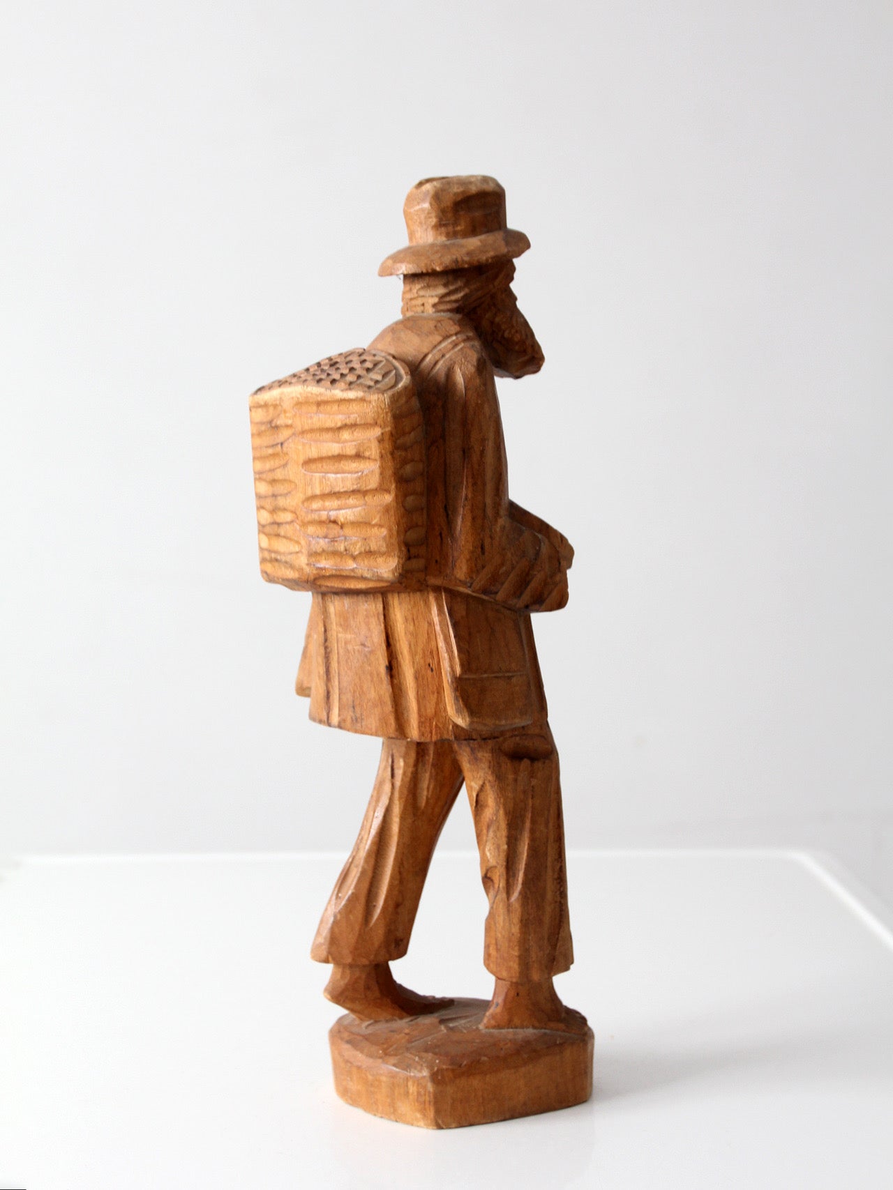 mid-century folk art carved wood peddler figure