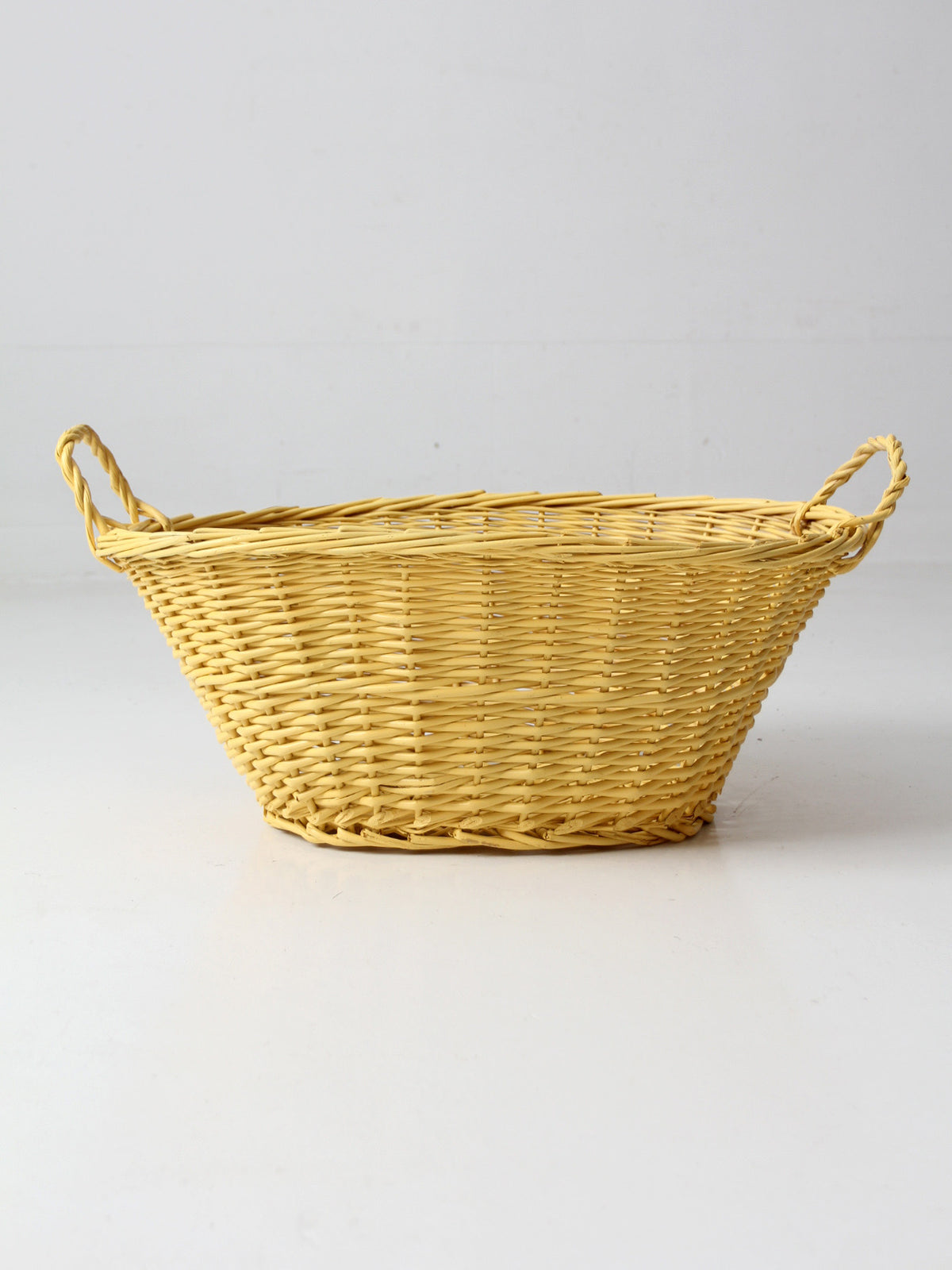 vintage yellow wicker laundry basket