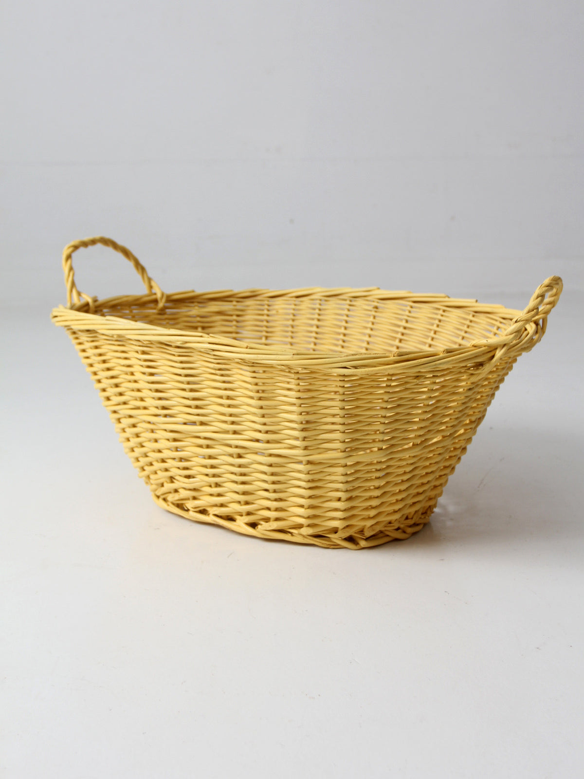 vintage yellow wicker laundry basket