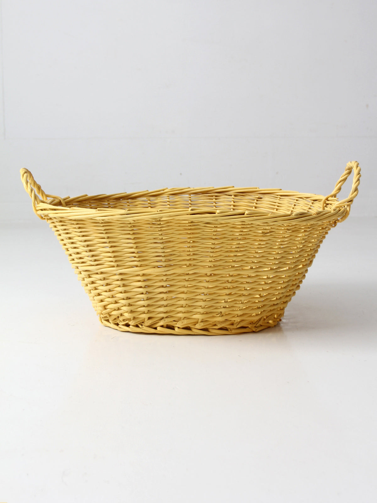 vintage yellow wicker laundry basket