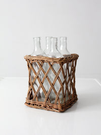 vintage wicker bottle basket with glass bottles
