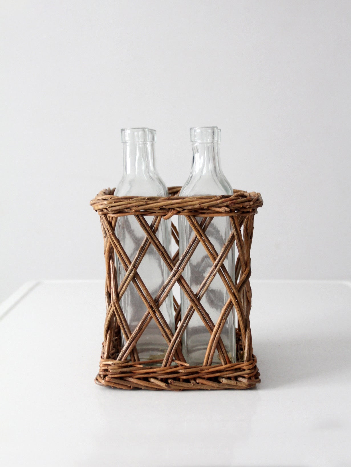 vintage wicker bottle basket with glass bottles